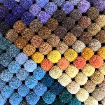 delinear's poms show more than one hundred possible colors for your custom rug. Color matching is also available.